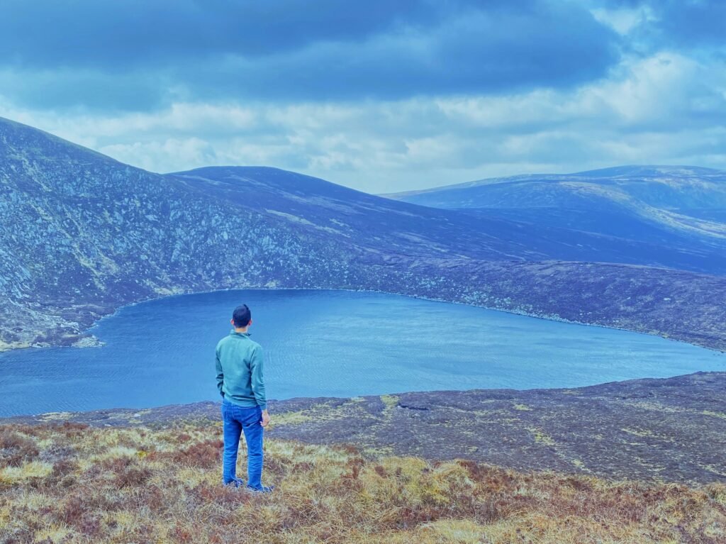 A person standing at the top of a mountain
